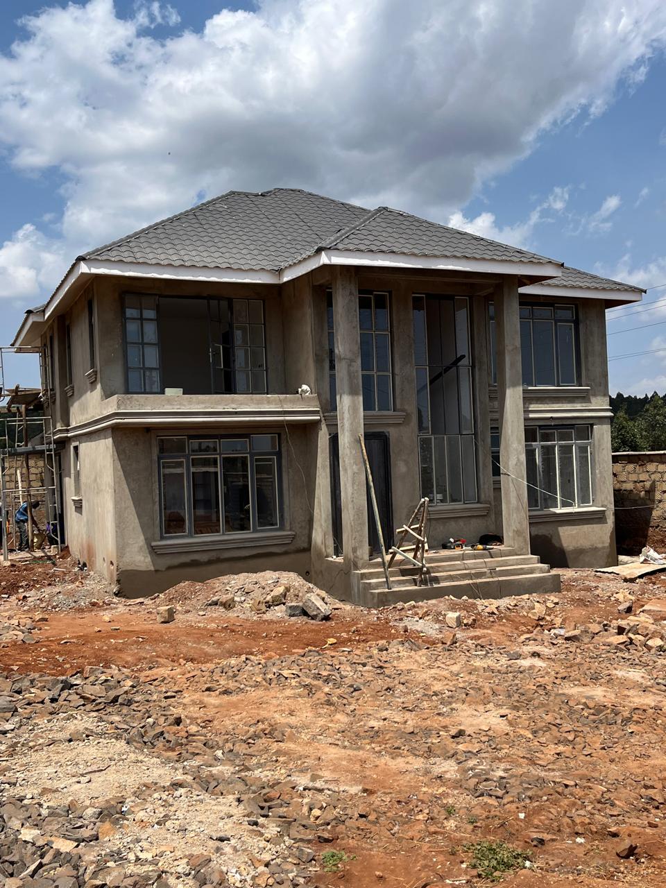 Front elevation of a Cedar Homes maisonette with roof, columns and entrance steps built, September 2026